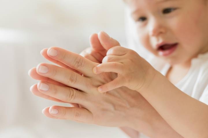 close-up-mother-baby-playing-with-hands